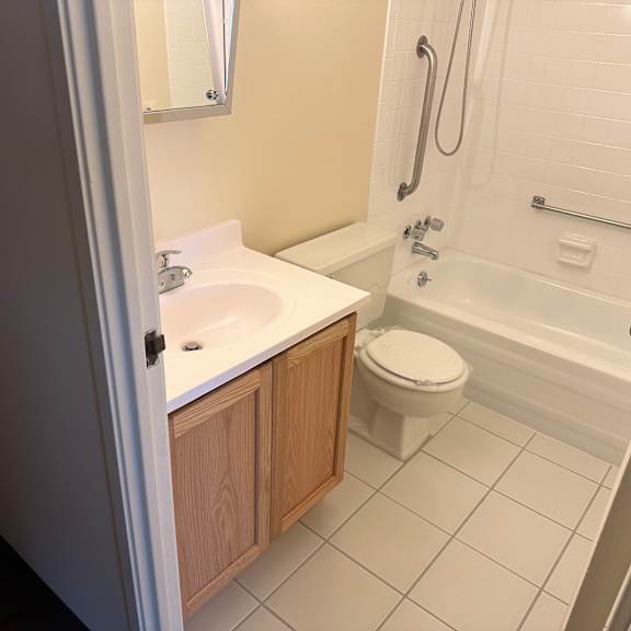 a small bathroom with a sink toilet and bath tub