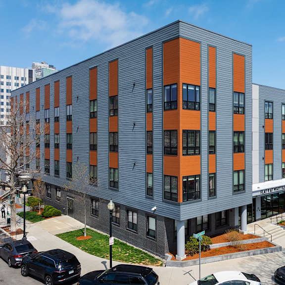 a modern building with orange and grey panels.