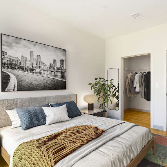 a bedroom with a large bed and a black and white photo on the wall.