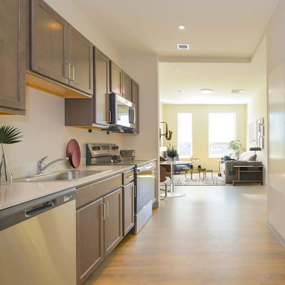 a modern kitchen with a dining area in the background.