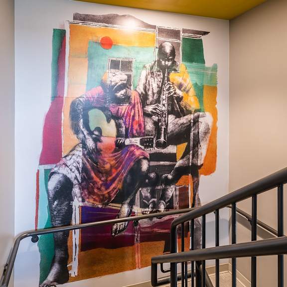 a painting of a man with a gun is on the wall.