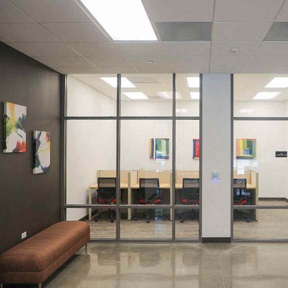 a conference room with glass doors and a table and chairs