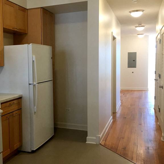 a kitchen with a refrigerator and a stove and