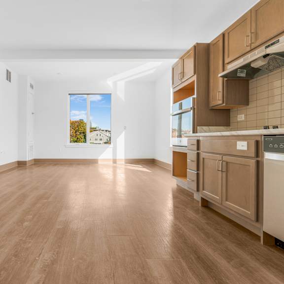 a kitchen with wooden floors and a window