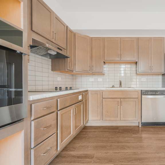 a kitchen with wooden cabinets and stainless steel appliances