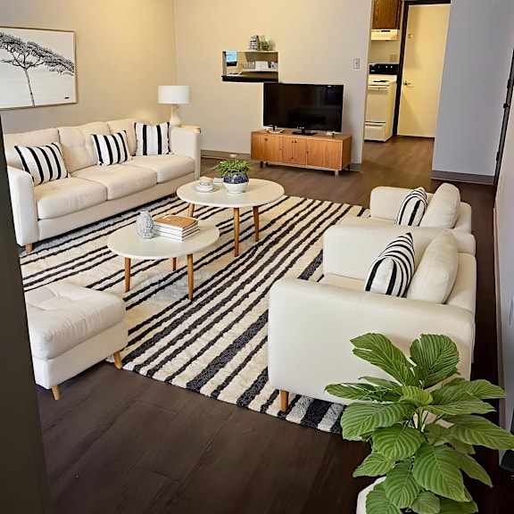 a living room with a white couch and a coffee table.