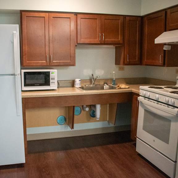 a kitchen with white appliances and wooden cabinets