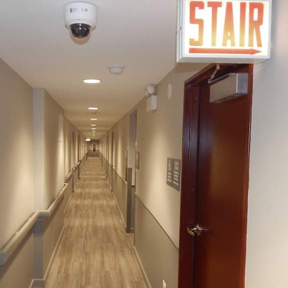 a long hallway with doors and a star sign on the side