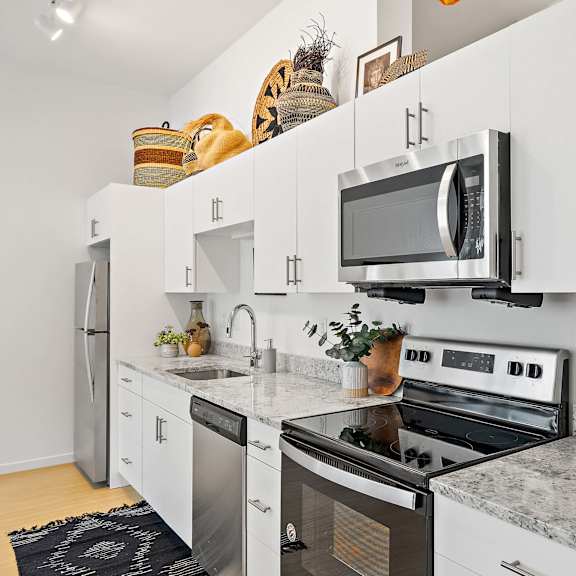 kitchen with appliances and white cabinets  at the freelon at sugar hill, detroit, michigan 48201