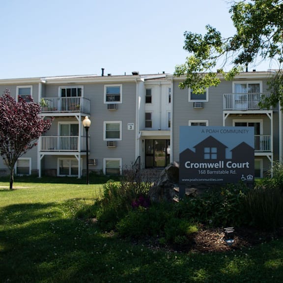 an apartment building with a sign that reads crownwell court