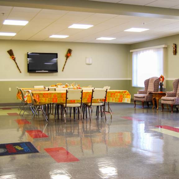 a room with a table set for a meeting with chairs around it.