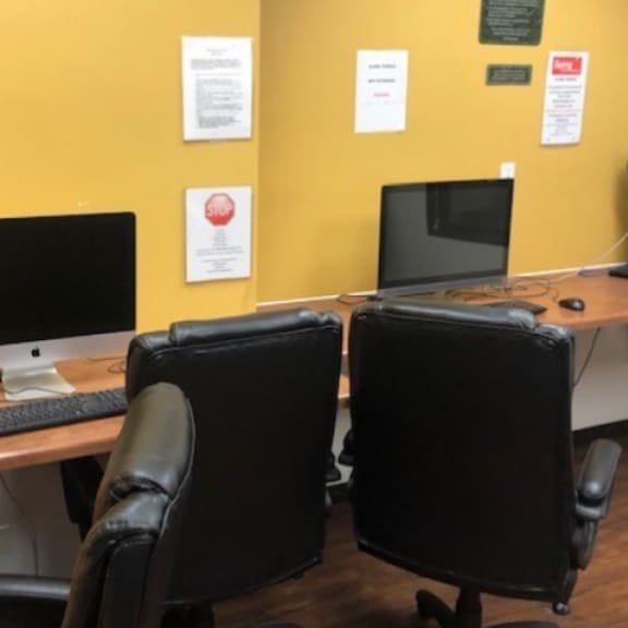 a desk with two computer monitors on it