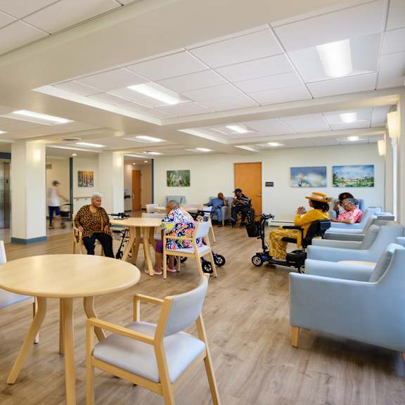 a room with a wooden floor and a table with chairs.