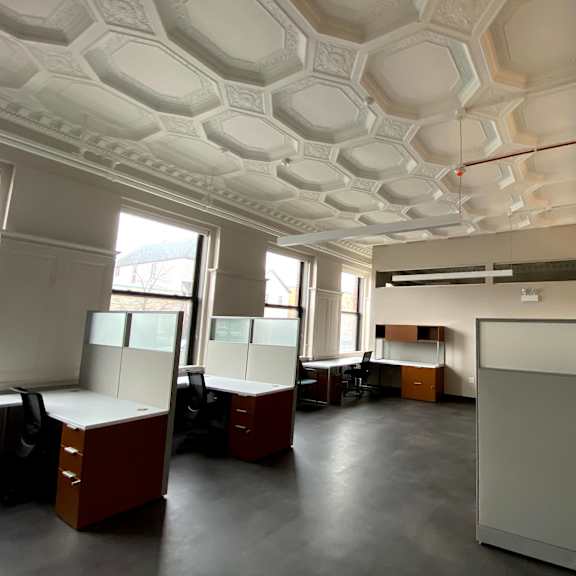 a white ceiling with a geometric pattern and a red line running through the middle.