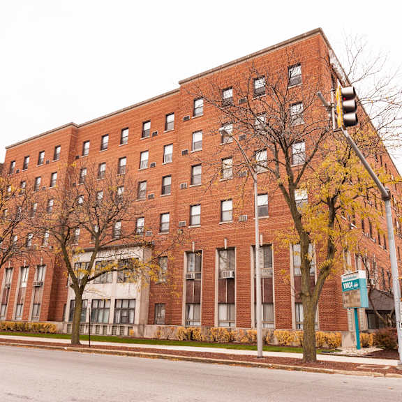 a large red brick building with a blue sign on the front.