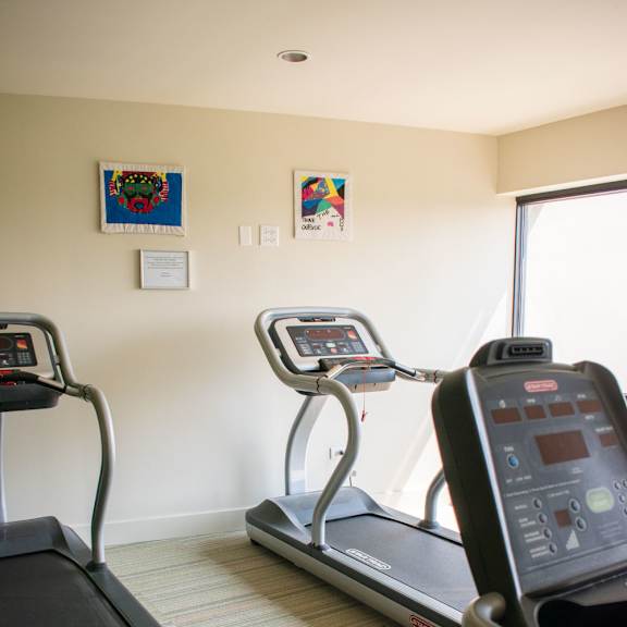 a room with two treadmills and two exercise bikes