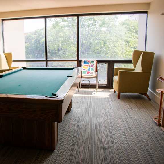 a large room with a pool table and a balcony