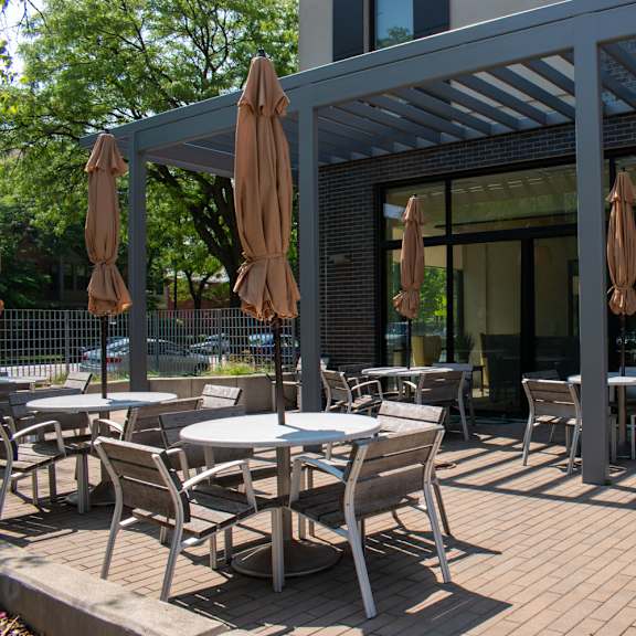 a patio with tables and chairs
