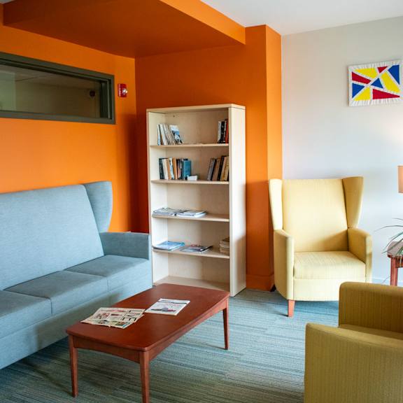 a living room with orange and white walls