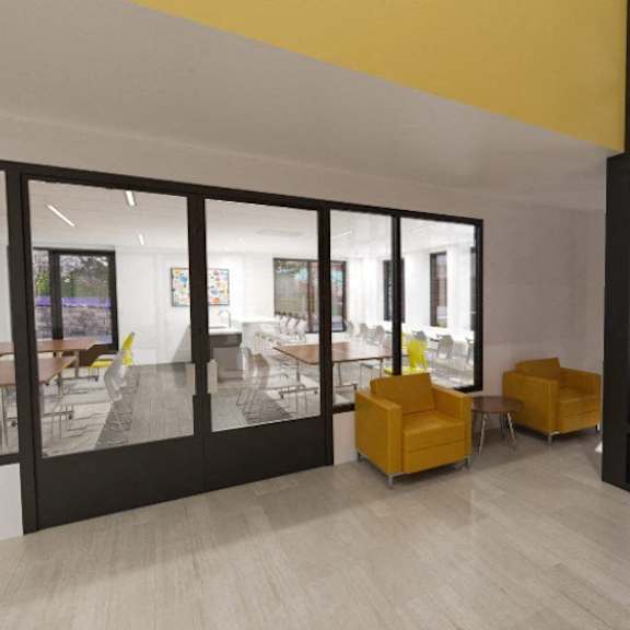 a living room with yellow chairs and a glass door