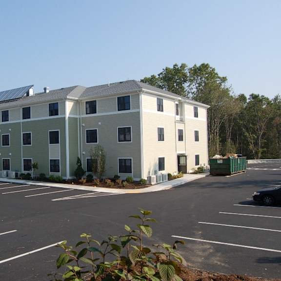 an apartment building with solar panels on the roof