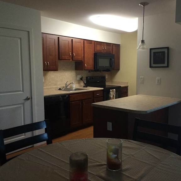 an empty kitchen with a table and chairs in it