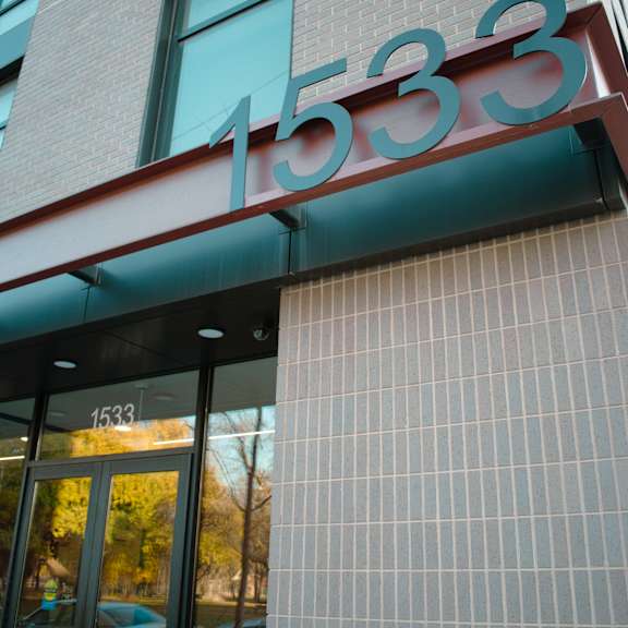 a building with a glass door and a sign that reads 1533.