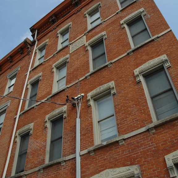 a tall brick building with windows and a street light