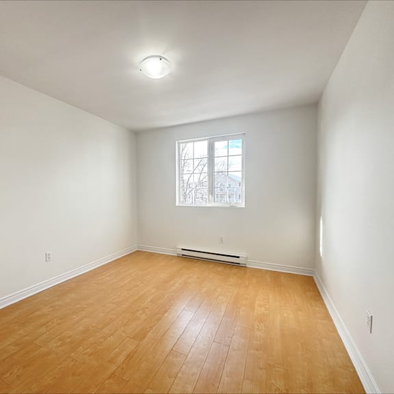 empty room with wooden floor and a window.