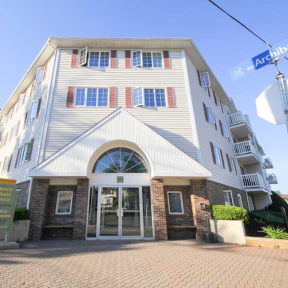 a large white building with a sign that says "residence" in front of it.