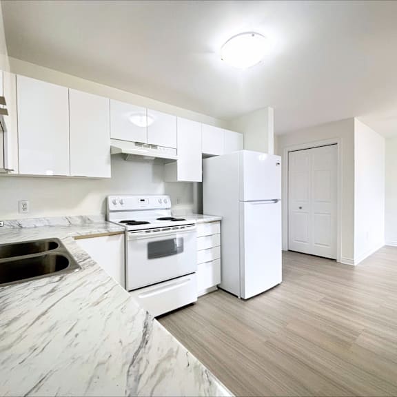 a kitchen with white appliances and cabinets.