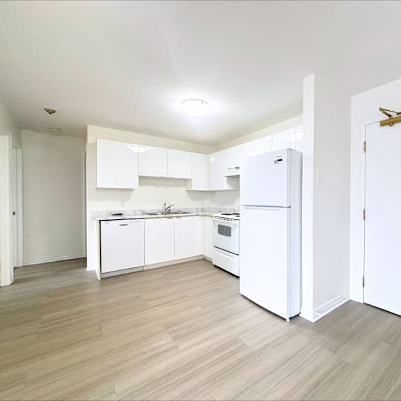 a kitchen with white appliances and cabinets.