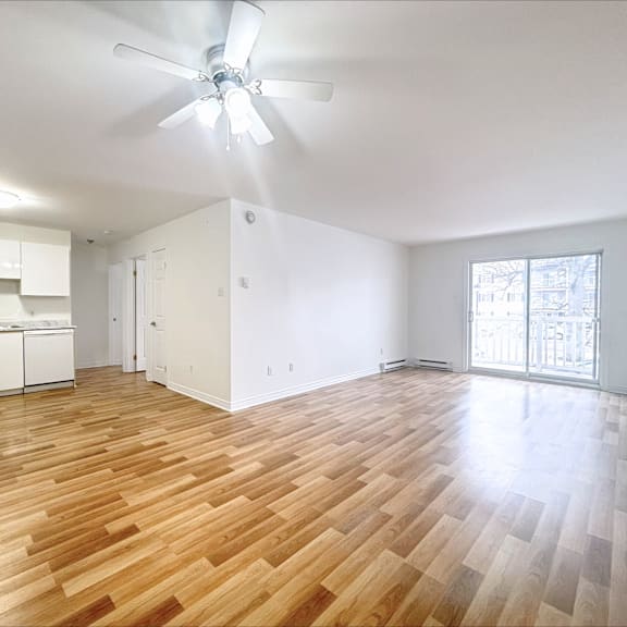 a room with wooden flooring and a ceiling fan.