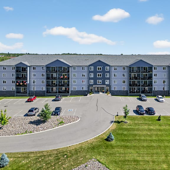 a large building with a parking lot in front of it.