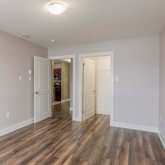 a room with a wooden floor and white walls.