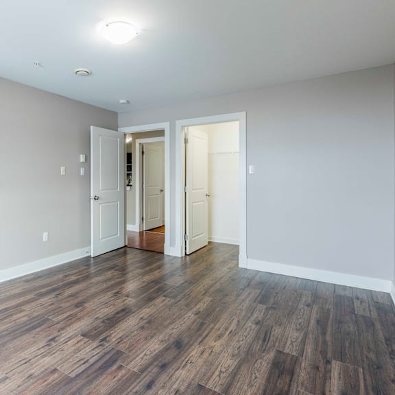 a room with wooden floors and white walls.