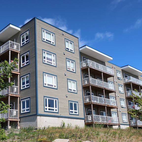 a modern apartment building with balconies and windows.