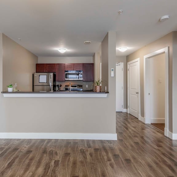 a kitchen with a refrigerator, microwave, and oven.