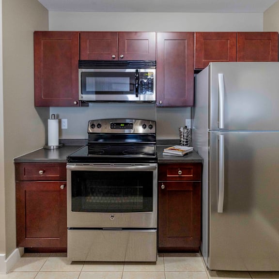a kitchen with a stainless steel refrigerator, oven, and microwave.