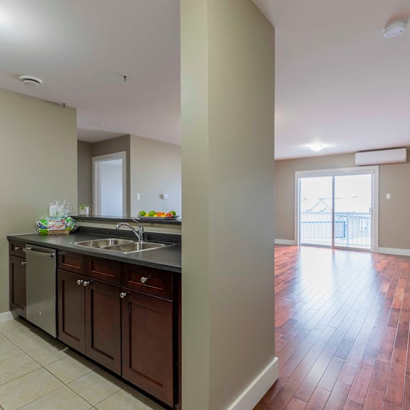 a kitchen with brown cabinets and a tiled floor.