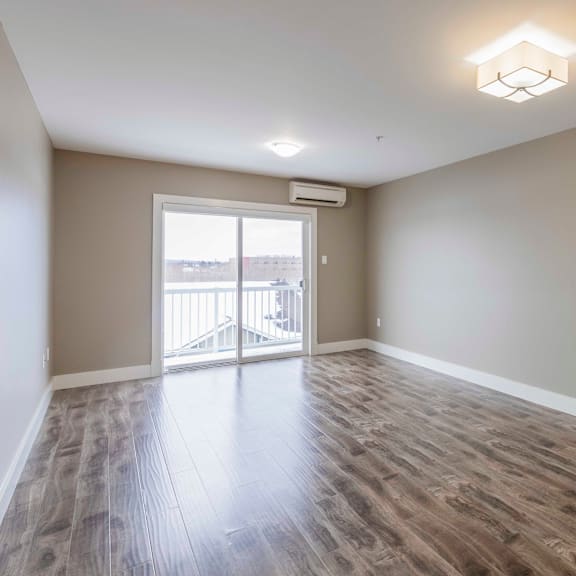 a room with a sliding glass door leading to a balcony.