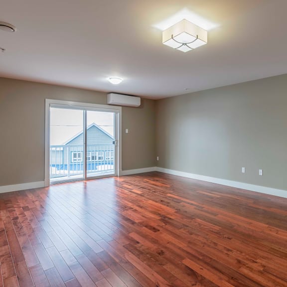 a room with wooden floors and a sliding glass door.