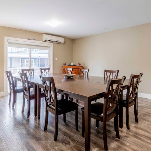 a dining room with a table and chairs.