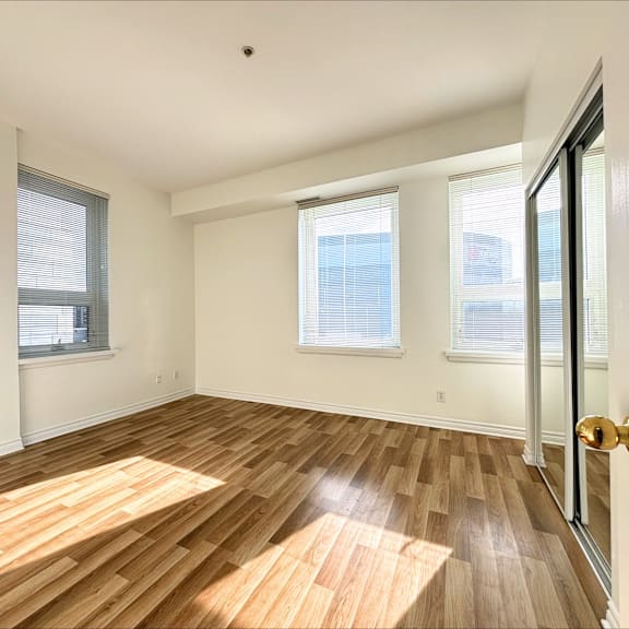 a room with wooden flooring and white walls.