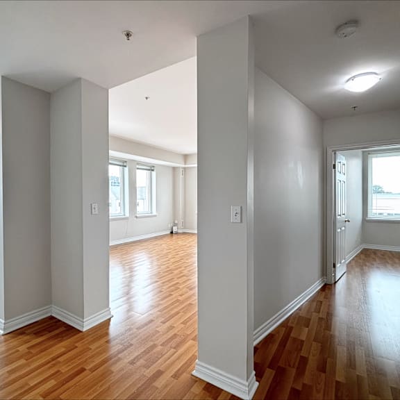 a room with wooden floors and white walls.