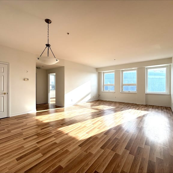 a room with wooden floors and a white door.