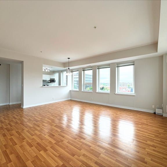 a large empty room with wooden floors and white walls.