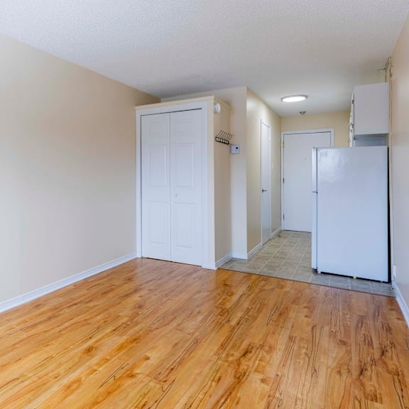 a room with wooden floors and white walls.