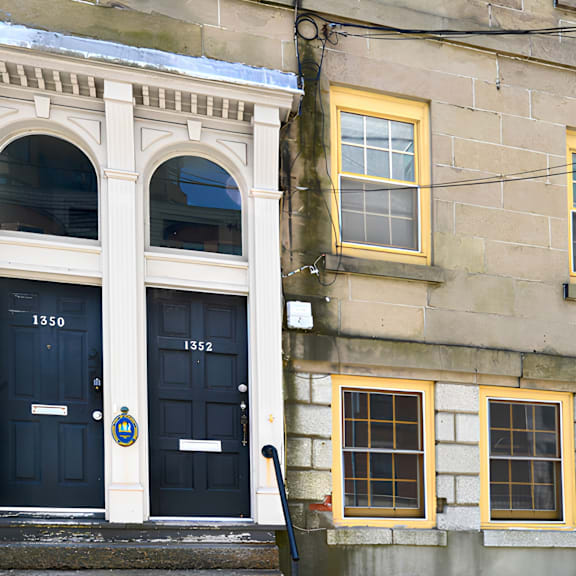 a building with a red door and a blue door with the number 1350 on it.
