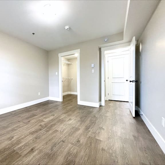 a room with wooden flooring and white walls.